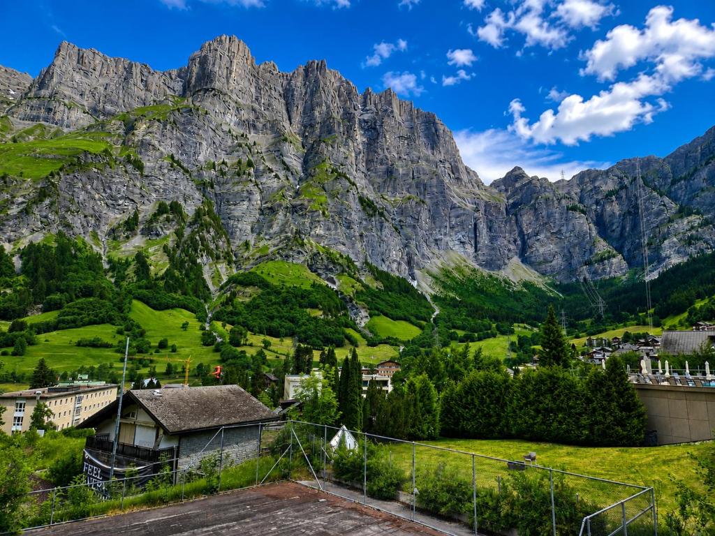 a village in front of a mountain at Schlossli-Le Petit Chateau in Leukerbad