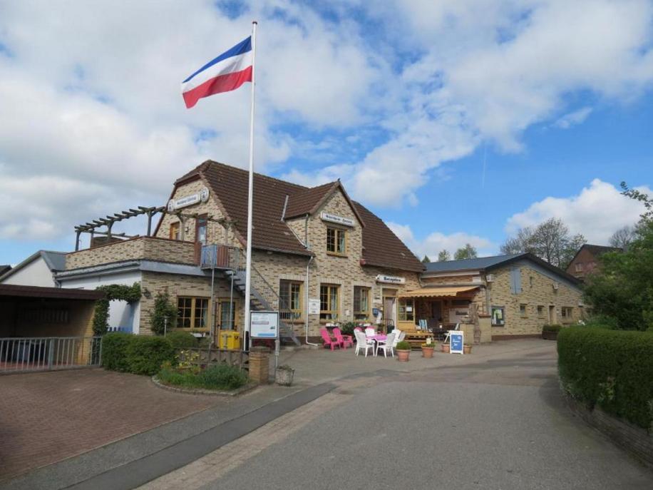 a flag flying in front of a house at Hotel Panorama in Wees