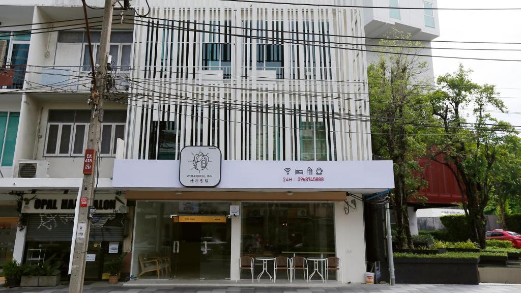 a building with a restaurant with chairs in front of it at Wonderful Bangkok in Bangkok