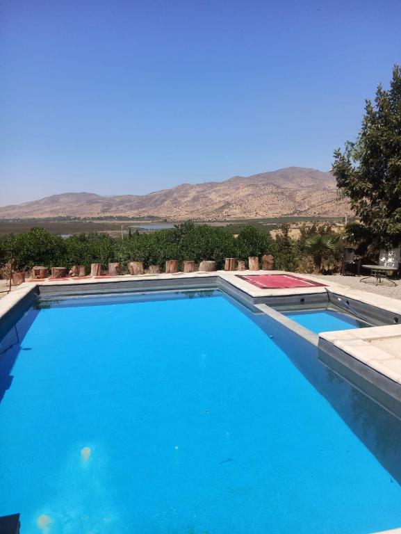 a swimming pool with mountains in the background at la casa del cerro in Olmué