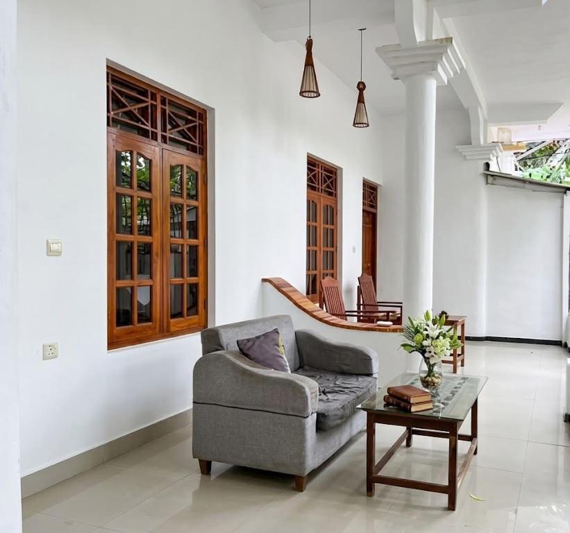 a living room with a couch and a table at Pearl Resort in Arugam Bay