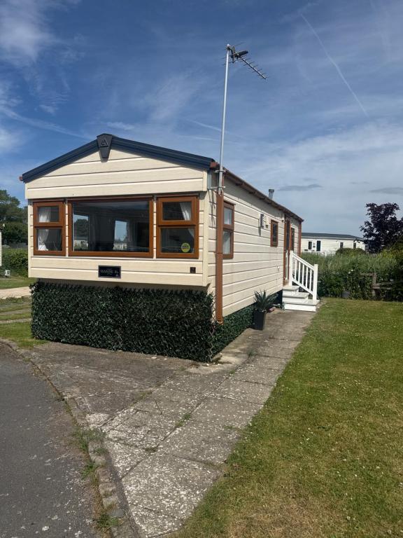 a tiny house is parked in a yard at Haighs caravan hire in Rhyl