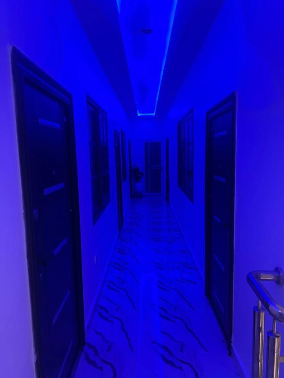 a hallway with blue lights in a room at Kingdom homes in Amanfro