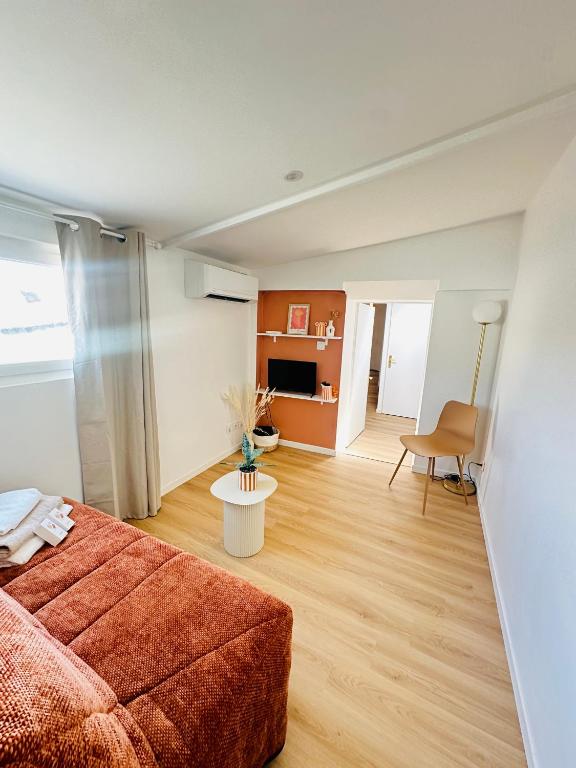 a living room with a couch and a table at Aytré plage in Aytré