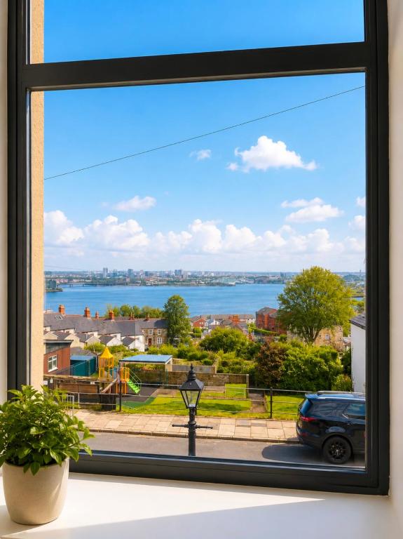 a window with a view of the water at 4 Bedroom Cardiff Bay View House in Cardiff