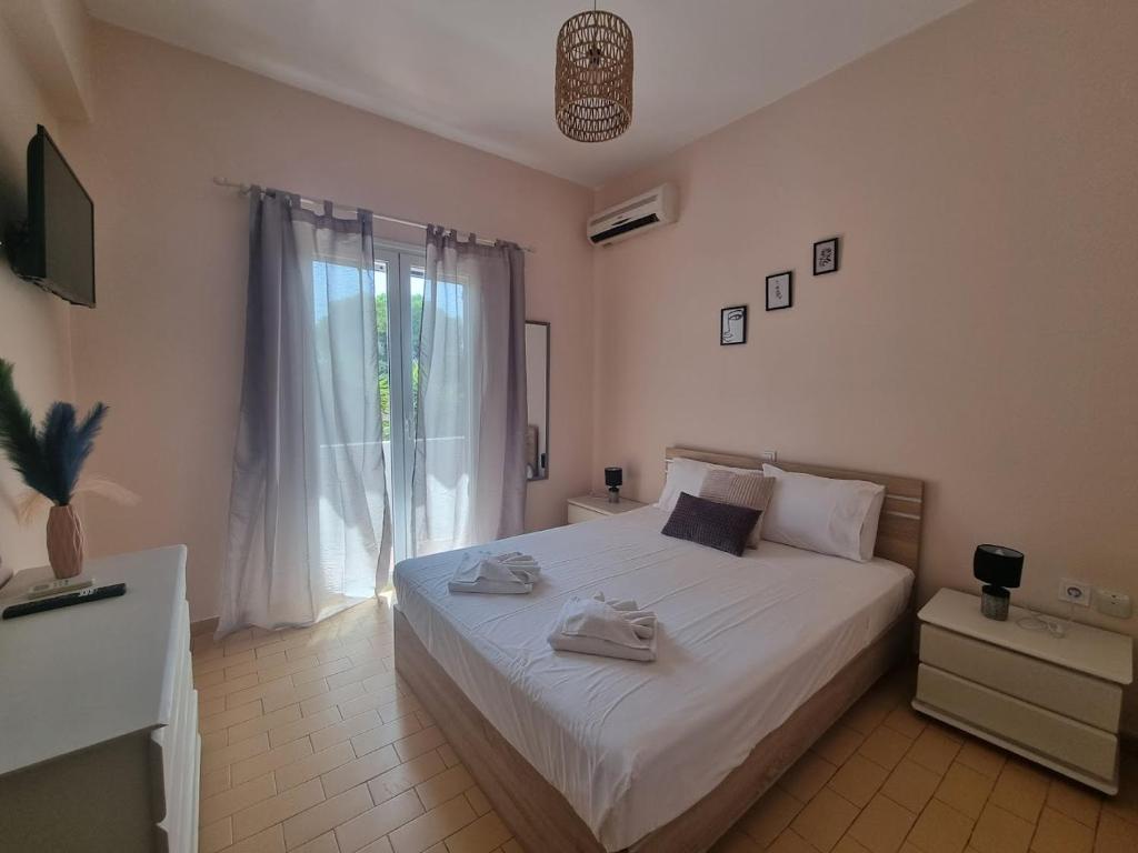 a bedroom with a bed with two towels on it at Seaside Garden House 7 in Dassia