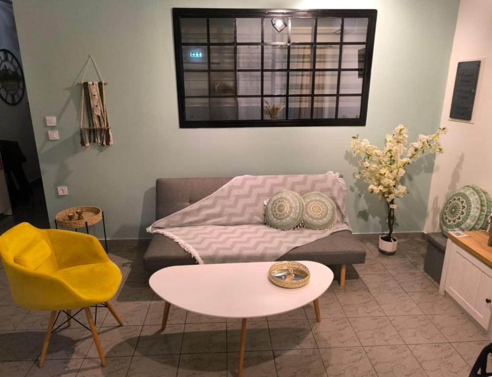 a living room with a couch and a table at Filoxenia house in Kremasti