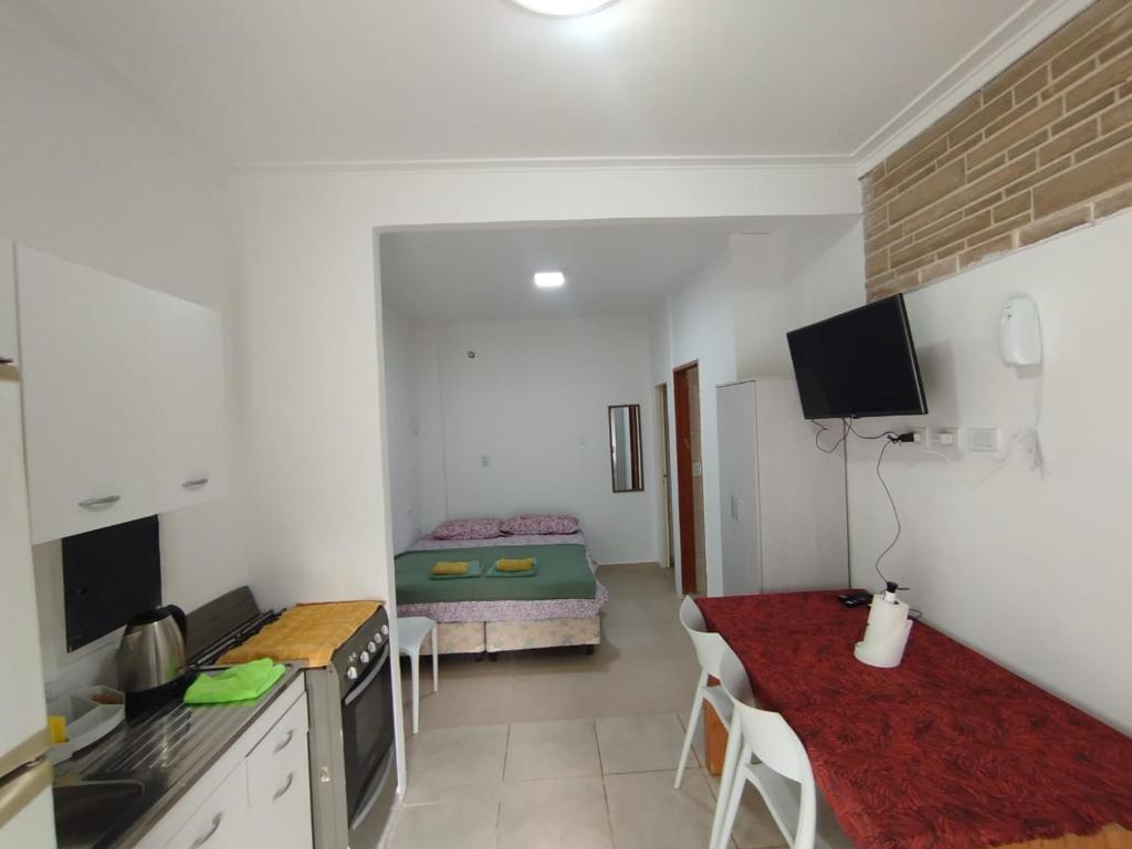 a kitchen and a living room with a table in a room at Aprt Belgrano 658 in Neuquén