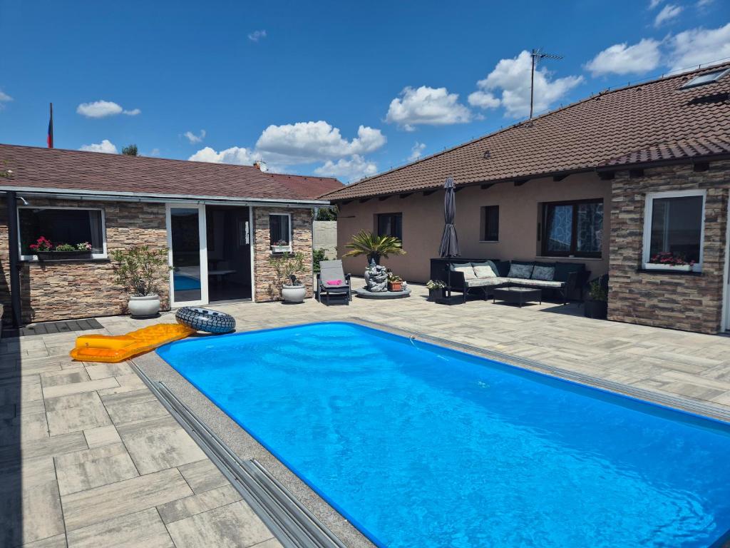 a swimming pool in the backyard of a house at Wellness Villa close to Prague in Kuchař