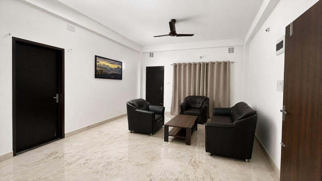a living room with two chairs and a table at KwaChen Stays in Panchanai