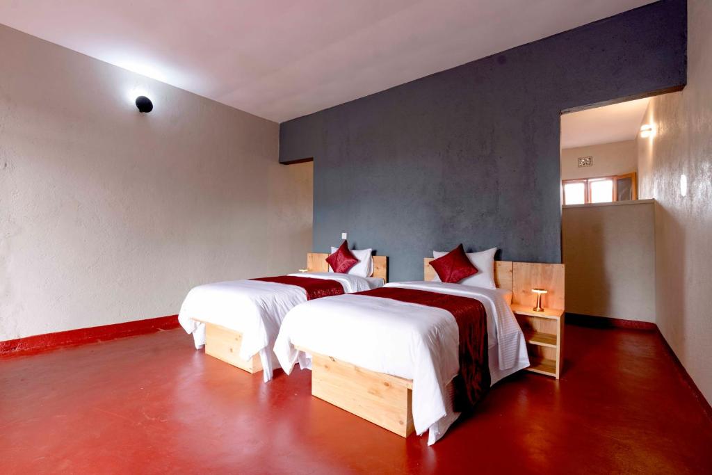 a bedroom with two beds in a room at Marera Eco Lodge in Karatu