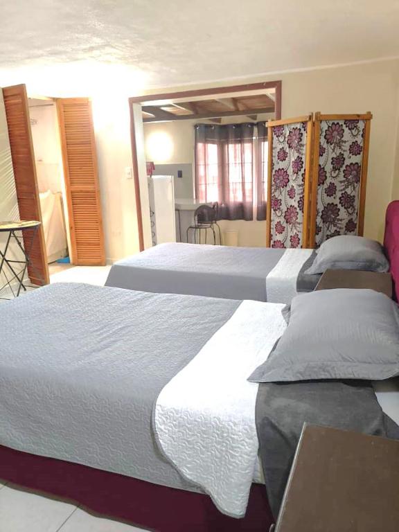 a bedroom with two beds with white sheets at Mejor relación Precio Comodidad in San Diego