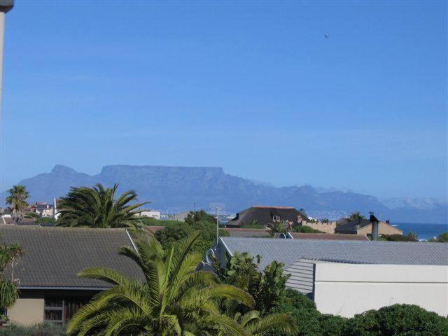 a view of a city with houses and palm trees at Melkbos Beach Cottage in Melkbosstrand