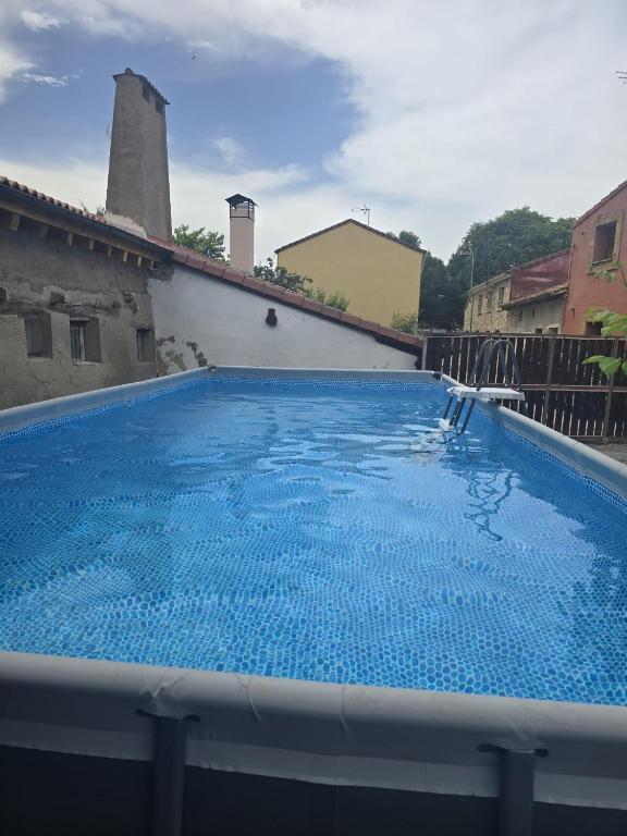 a large blue swimming pool in a building at La Casona del Rio Abion in Valdealvillo