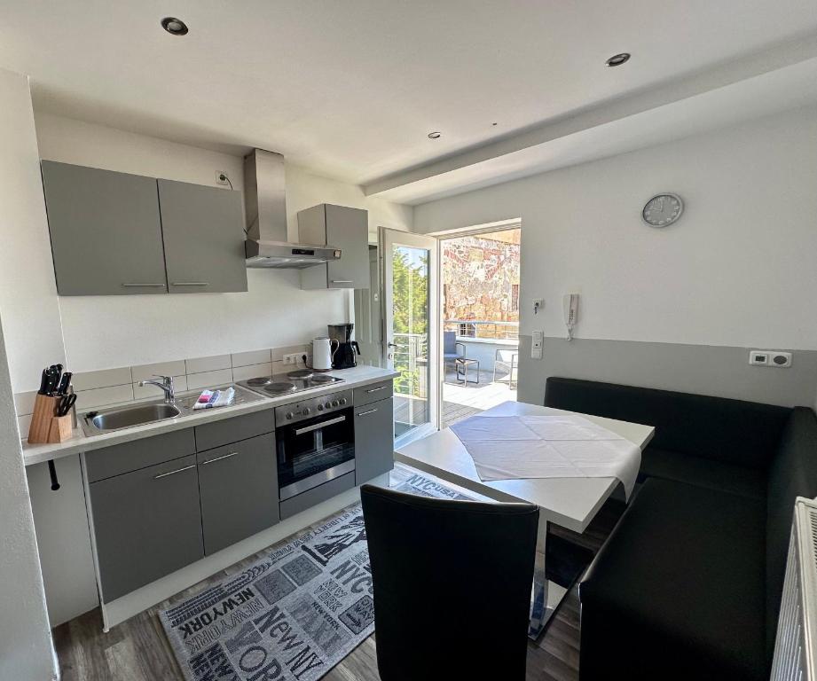 a kitchen with a sink and a table with a dining room at Comfort in Bamberg
