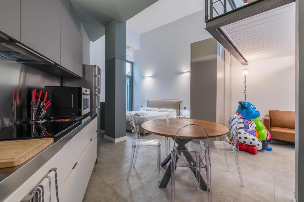a kitchen with a table and a dining room at Effealatapartments - EdenLoft in Senigallia