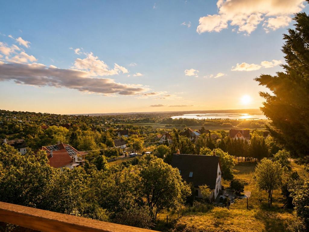 a view of a small town with the sunset in the background at Panoramahuis in Sukoró