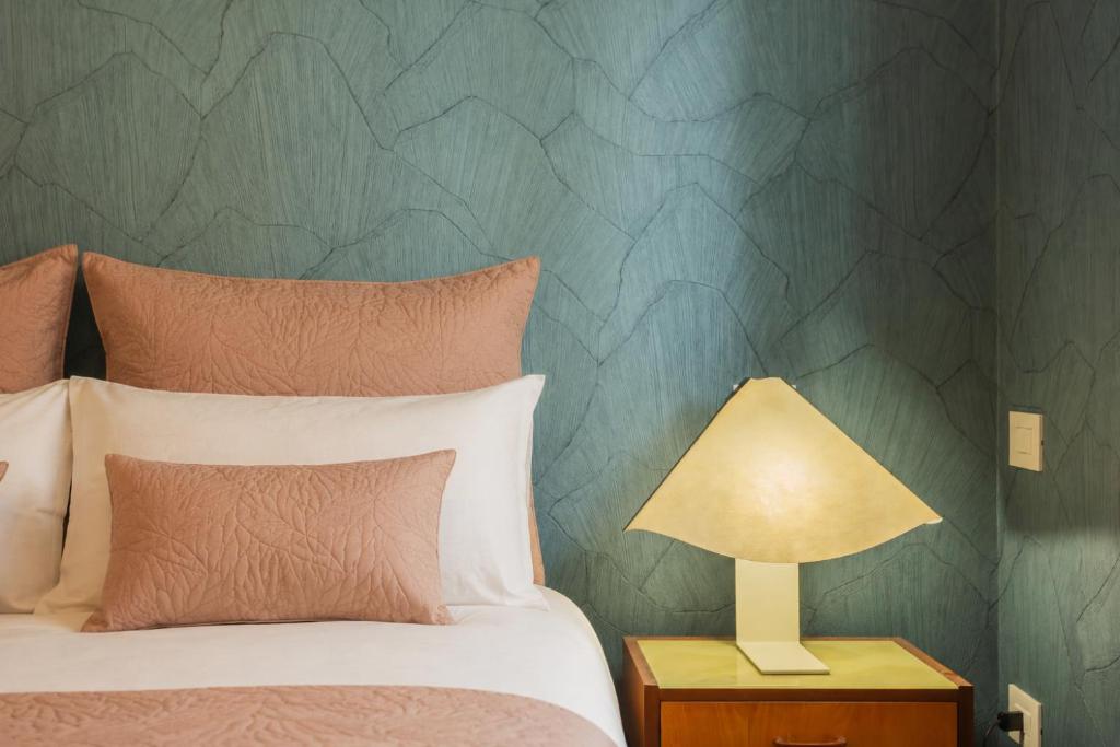 a bedroom with a bed and a lamp on a night stand at Wanderlust Experience Mood Apartment in Bitonto