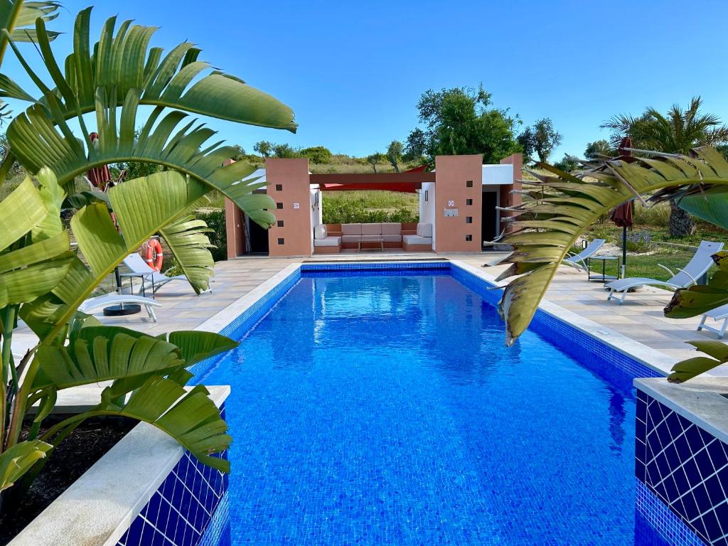 a swimming pool in front of a house at Patios do Algarve in Ferragudo