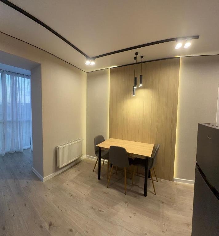 a dining room with a wooden table and chairs at Dream 71 in Lutsk