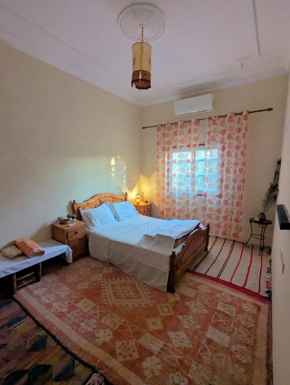 a bedroom with a large bed and a window at The Guests Haven House - Heart Of Skoura in Skoura
