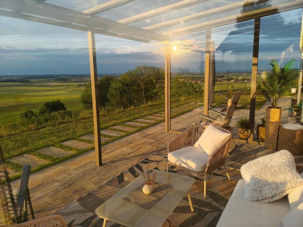 a patio with a table and chairs and a view at Morgenrot Panorama Apartment 1 - Terrasse in Gnotzheim