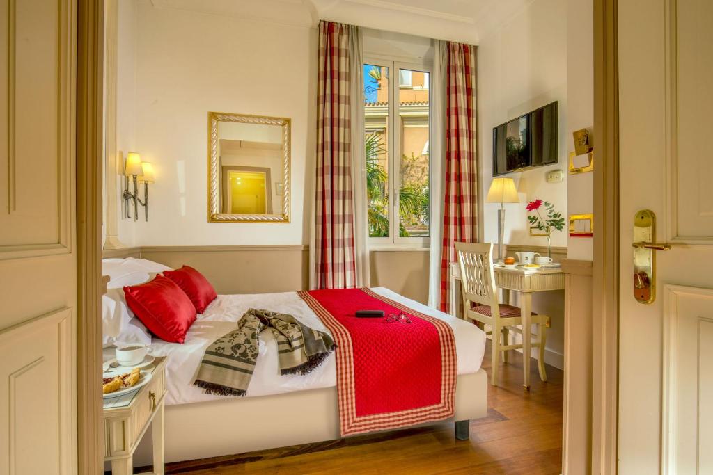 Postel nebo postele na pokoji v ubytování Hotel Villa Glori