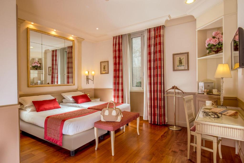 Postel nebo postele na pokoji v ubytování Hotel Villa Glori