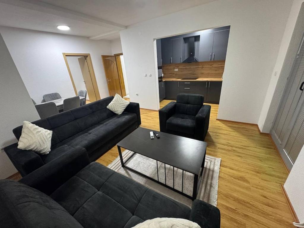 a living room with a couch and two chairs at DrimResidence in Struga