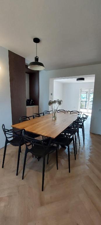 a wooden table and chairs in a living room at Zaczarowany Bieślin in Trzemeszno