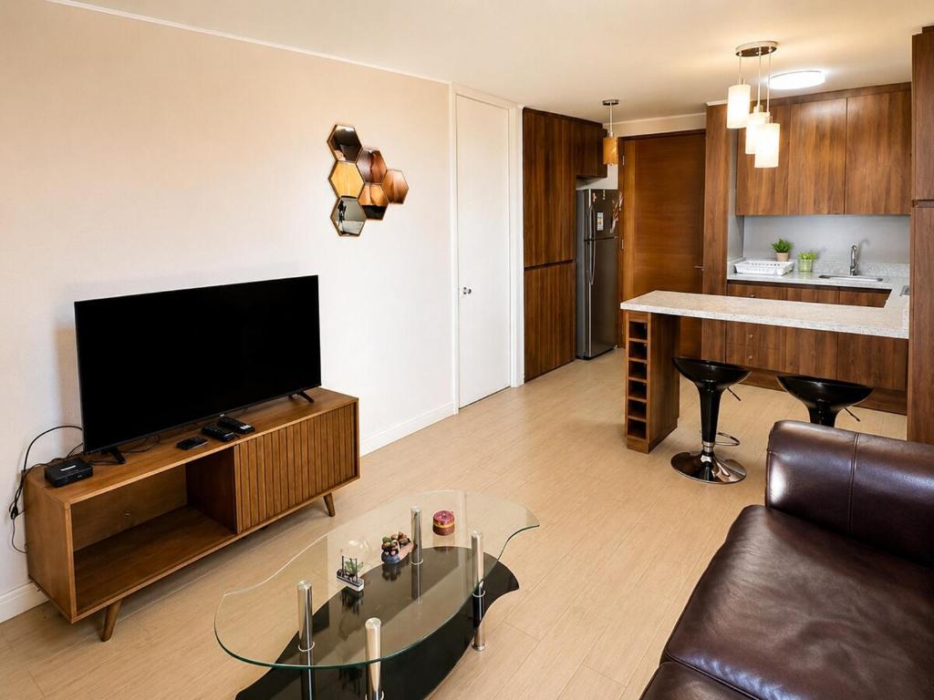 a living room with a large flat screen tv at Espacio parque 1D y 1B in Calama