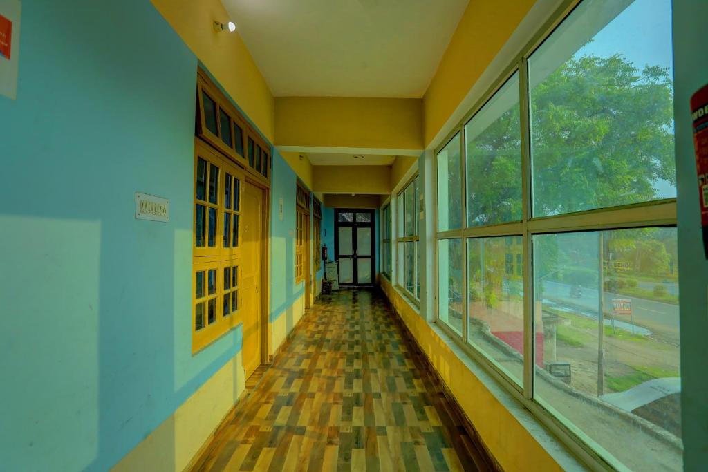 an empty hallway of a school building with windows at Hotel O AP Hotel in Sitāpur