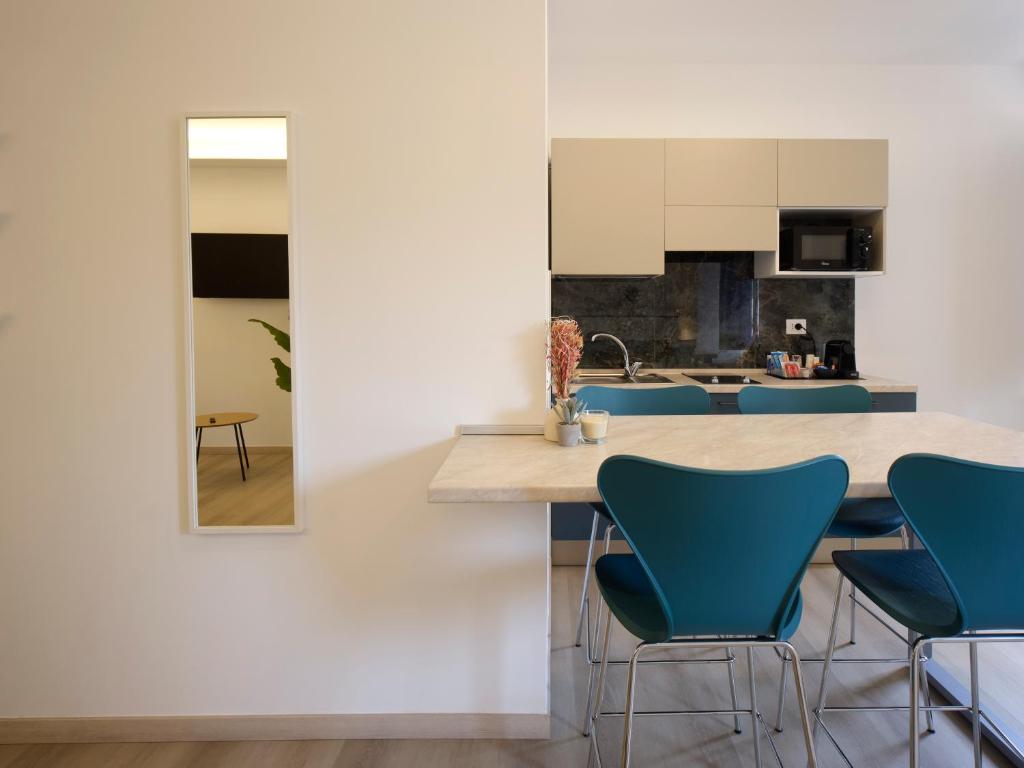 a kitchen with blue chairs and a counter top at Palazzo house in Palazzo
