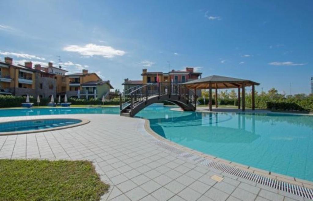 a large swimming pool with a bridge over it at Lucy in Sirmione