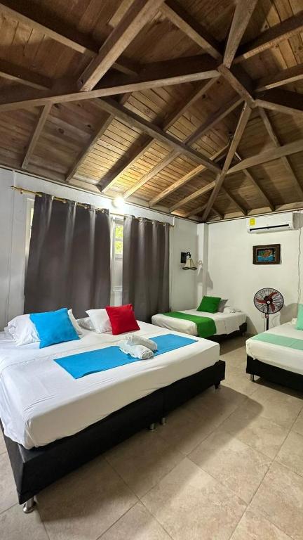 a bedroom with two beds in a room at Hotel Miramar Capurganá Casa de playa in Capurganá