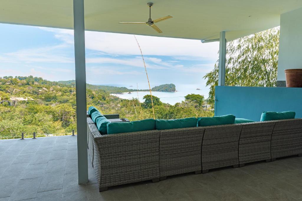 a living room with a couch and a view of the ocean at Villa Costa Vida Tower Suites in Quepos