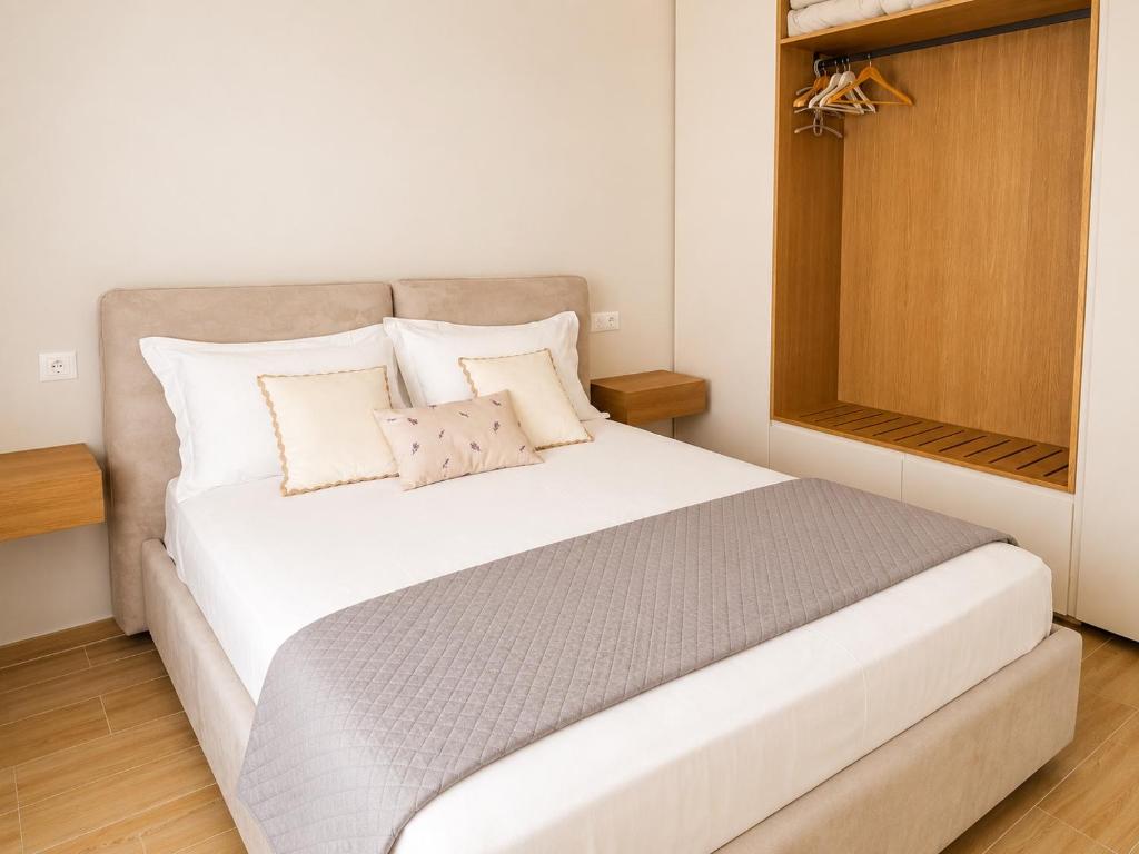 a bedroom with a large white bed with two pillows at Villa Safira in Durrës