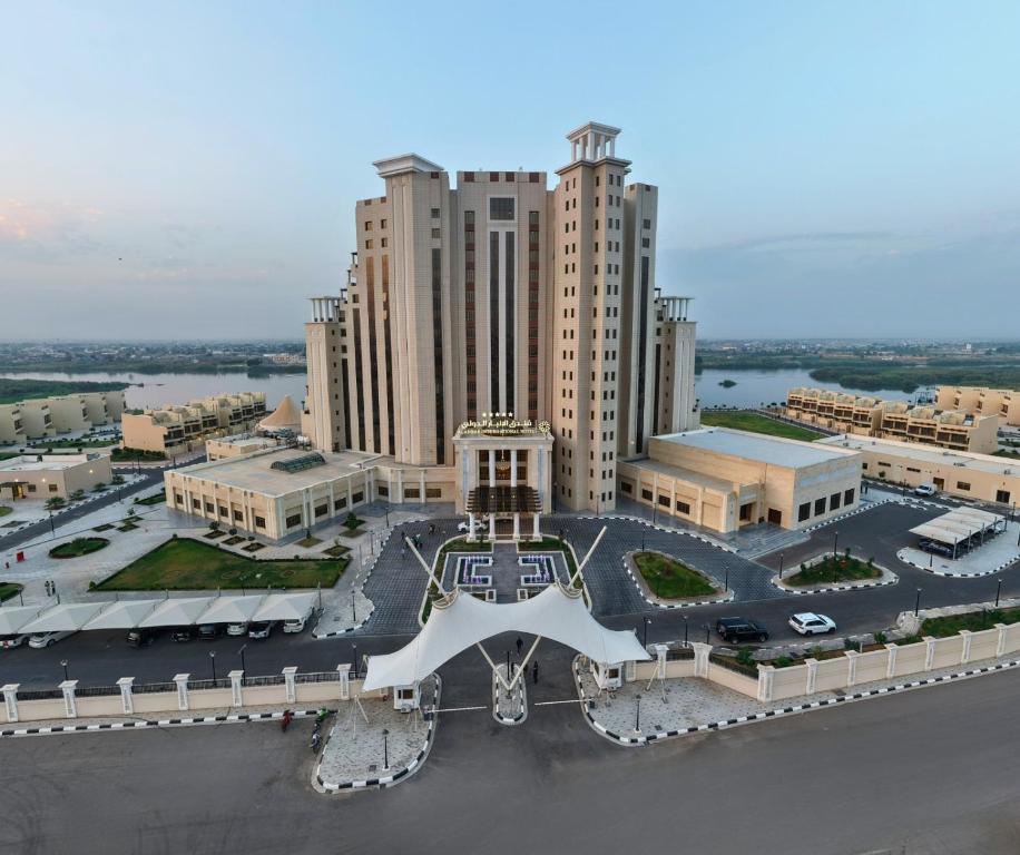 an aerial view of a large building with a parking lot at Anbar International Hotel in Kumaysh