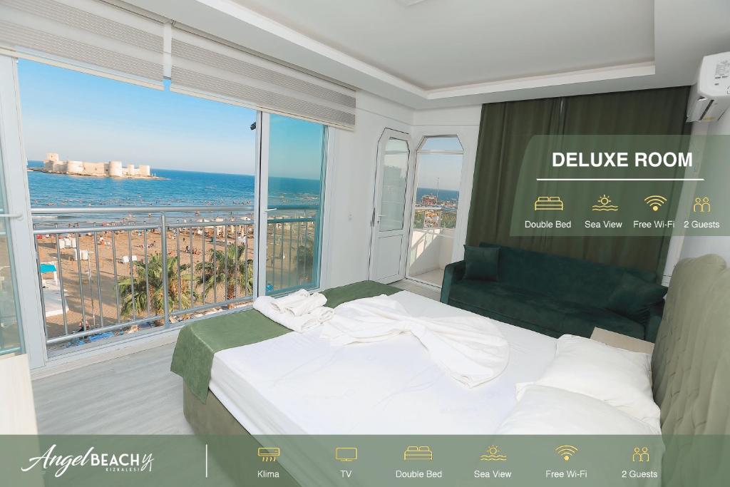 a bedroom with a bed and a view of the ocean at Hotel Angel Beach - Kızkalesi Mersin in Erdemli