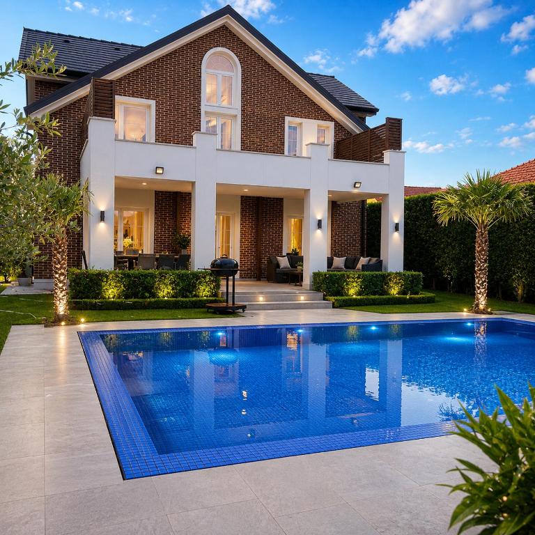 a swimming pool in front of a house at Villa Krasta in Elbasan