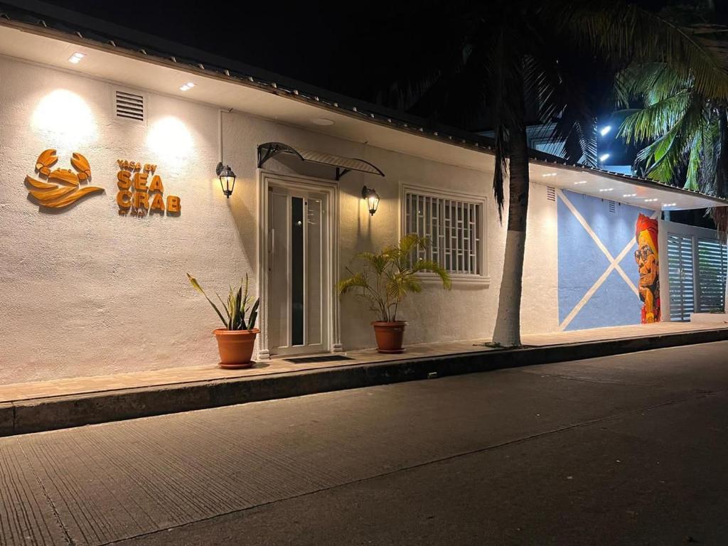 a white building with plants on the side of it at yasa by SEA CRAB in San Andrés