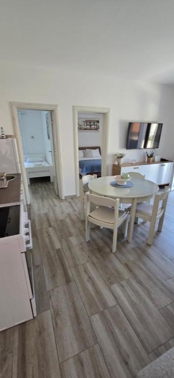a kitchen and dining room with a table and chairs at Apartmani Furesti 2 in Donji Stoliv