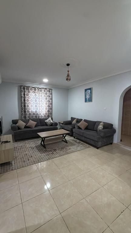 a living room with two couches and a coffee table at Al-Dana 6 in Al Wajh