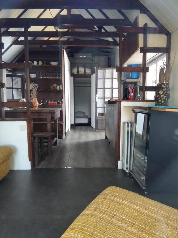 a room with a kitchen and a dining room at chalet les pieds dans l'eau in Neuvic
