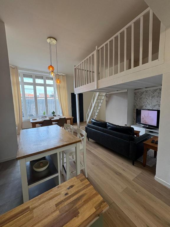 a living room and dining room with a loft at Le Cocon de St-Pierre in Calais