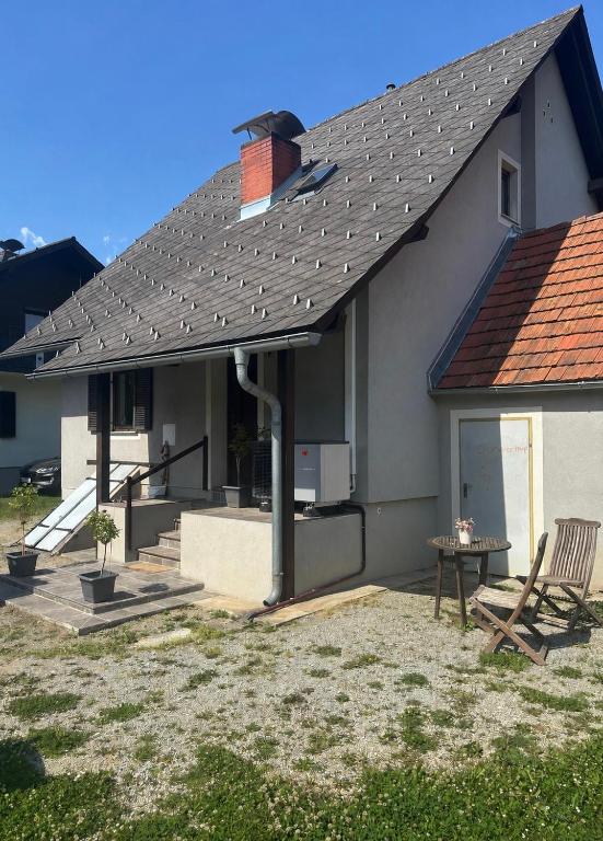 a house with a pitched roof and a patio at Ferienhaus Michi in Ursprung