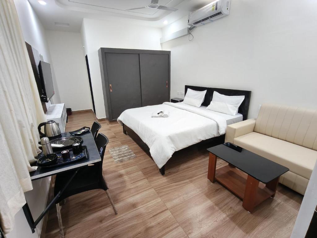 a hotel room with a bed and a couch at Hotel Seven Dreamers in Kākināda