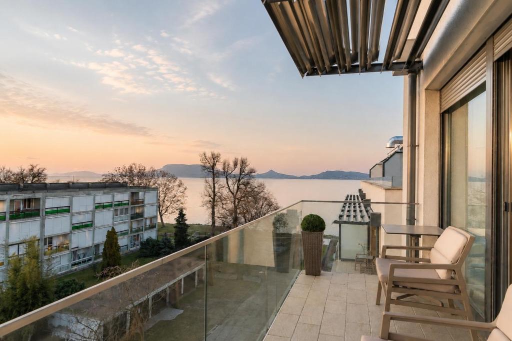 a balcony with a view of the water at Sunset Resort 410 in Fonyód