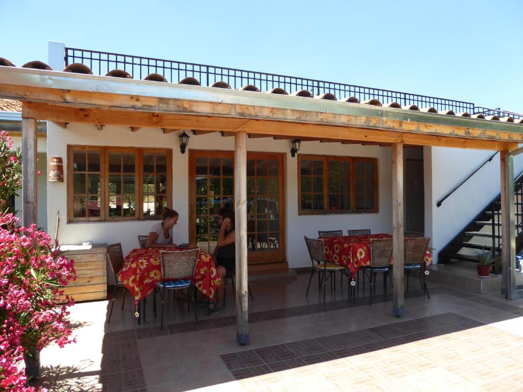 a woman sitting at a table on a patio at La Maravilla Lodge in Vilches