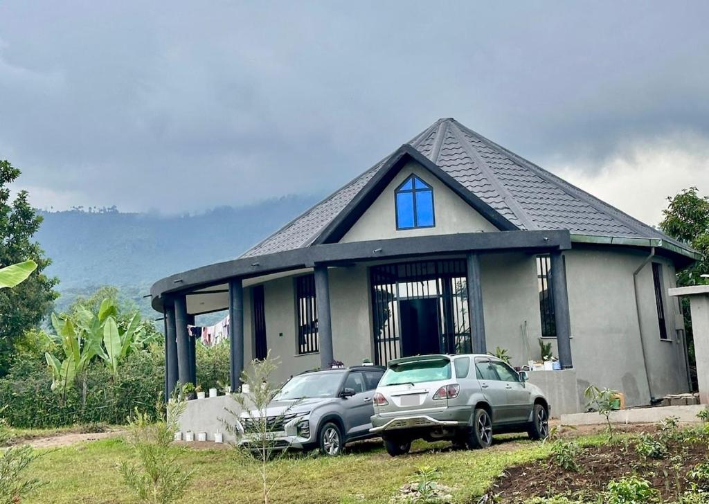 a house with a car parked in front of it at Hilm cottage in Āwasa